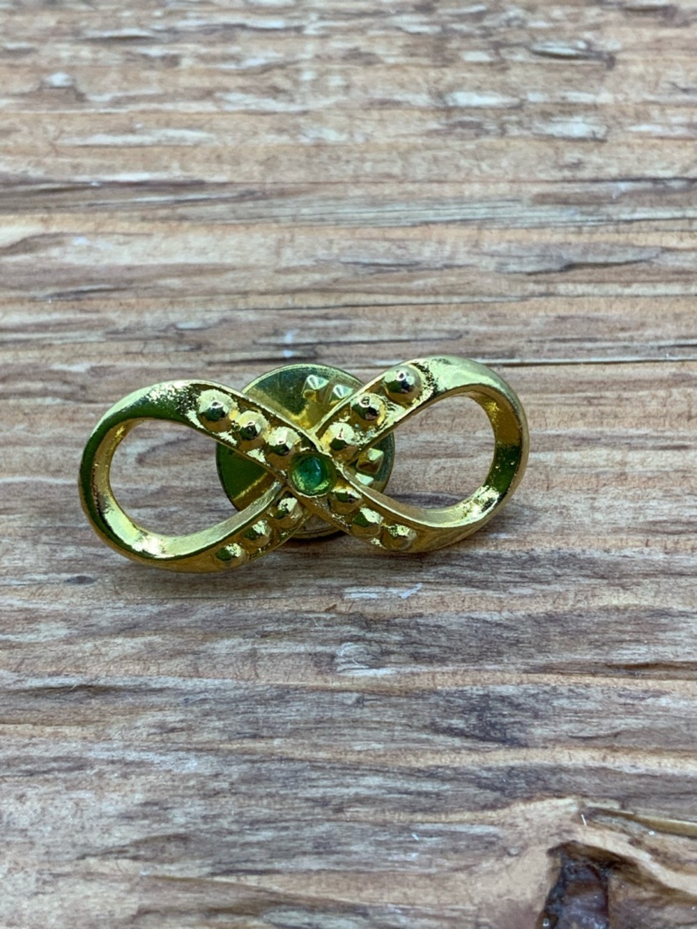 Hattie Carnegie Vintage Gold Tone Emerald Accent Infinity Pin